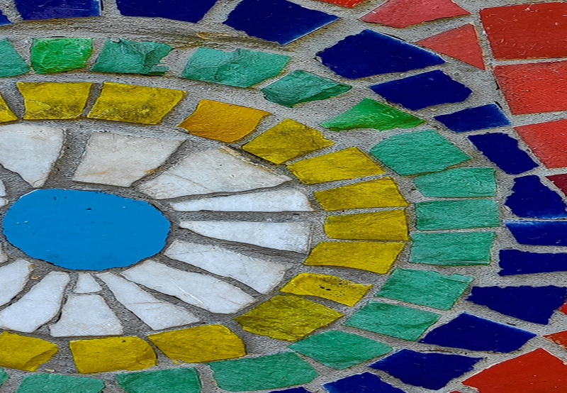 a mosaic with somewhat uneven pieces radiating out from the center